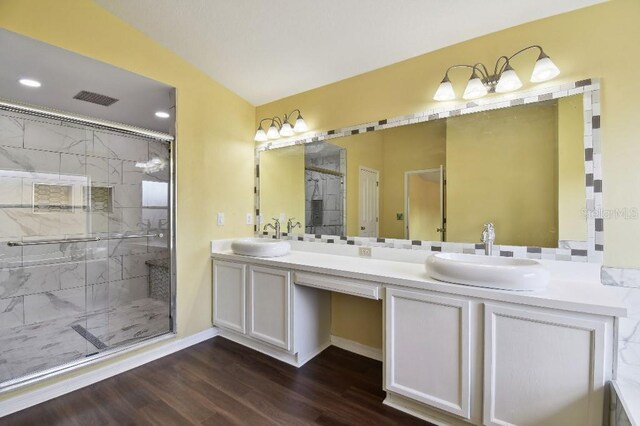 27012 Sea Breeze Way, Wesley Chapel, FL 33544 - bathroom with a shower stall, double vanity, wood finished floors, and baseboards