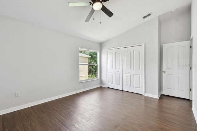 27012 Sea Breeze Way, Wesley Chapel, FL 33544 - unfurnished bedroom with lofted ceiling, dark wood finished floors, a closet, baseboards, and ceiling fan