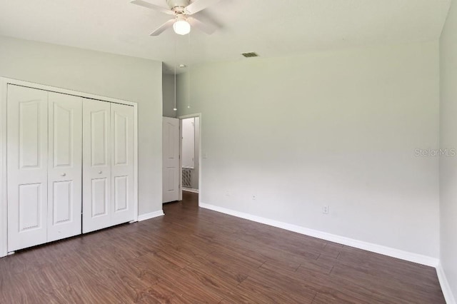 27012 Sea Breeze Way, Wesley Chapel, FL 33544 - unfurnished bedroom featuring baseboards, dark wood finished floors, a closet, and ceiling fan