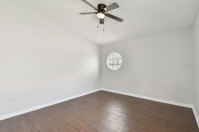 27012 Sea Breeze Way, Wesley Chapel, FL 33544 - spare room featuring a ceiling fan, dark wood-style floors, baseboards, and vaulted ceiling