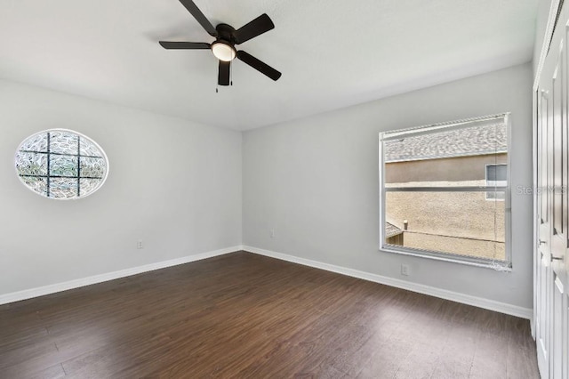 27012 Sea Breeze Way, Wesley Chapel, FL 33544 - empty room with dark wood-type flooring, ceiling fan, and baseboards