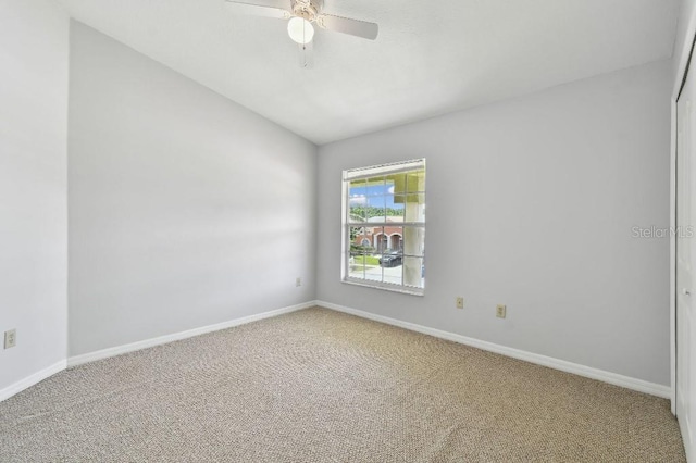 27012 Sea Breeze Way, Wesley Chapel, FL 33544 - spare room with carpet flooring, baseboards, and lofted ceiling