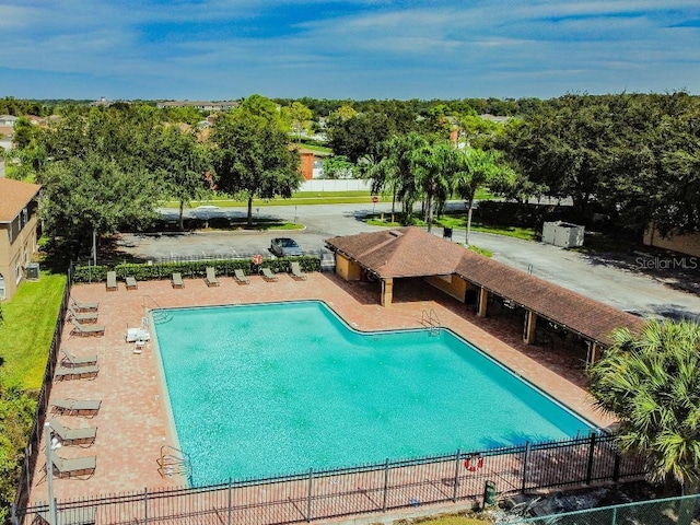 27012 Sea Breeze Way, Wesley Chapel, FL 33544 - community pool with a patio and view of scattered trees