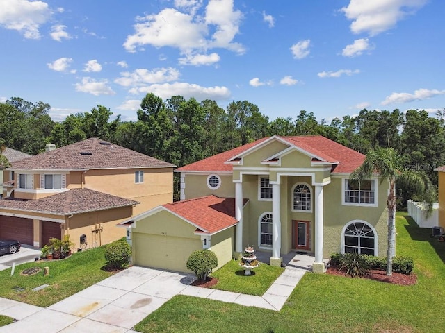 27012 Sea Breeze Way, Wesley Chapel, FL 33544 - view of front of home with driveway, a front yard, a garage, and stucco siding