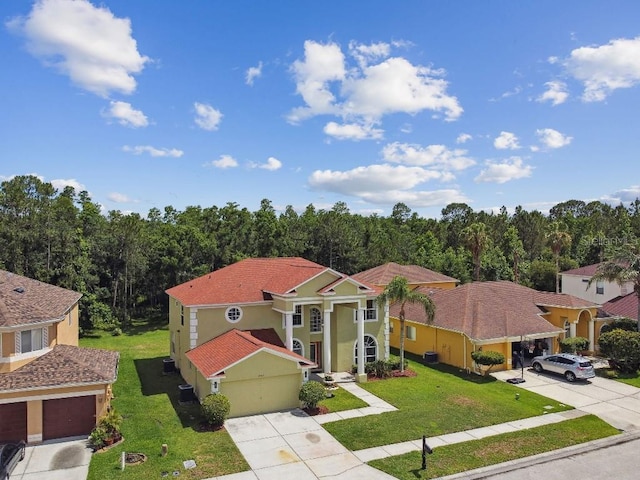 27012 Sea Breeze Way, Wesley Chapel, FL 33544 - view of front of property with driveway, a garage, a front yard, and stucco siding
