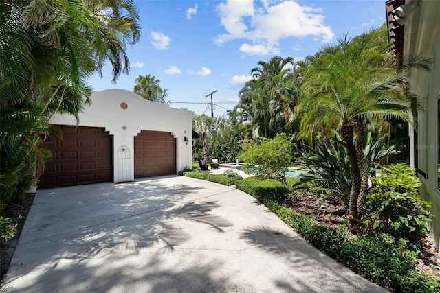 garage with concrete driveway