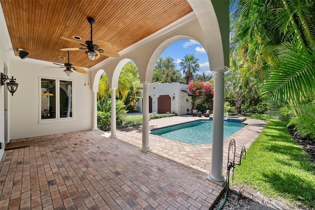 swimming pool featuring ceiling fan and a patio area