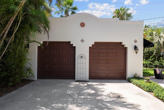 mediterranean / spanish home with stucco siding and a garage