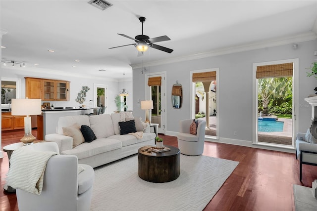 living area featuring a ceiling fan, crown molding, dark wood finished floors, recessed lighting, and baseboards