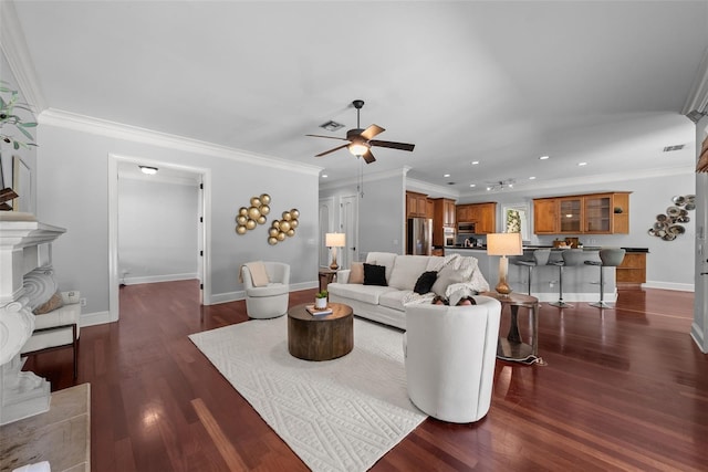 living room with a ceiling fan, recessed lighting, dark wood-style flooring, baseboards, and ornamental molding