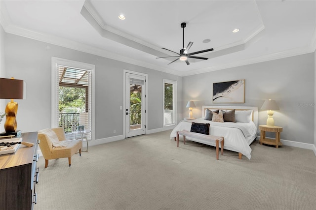 bedroom featuring access to exterior, light colored carpet, a tray ceiling, baseboards, and ornamental molding