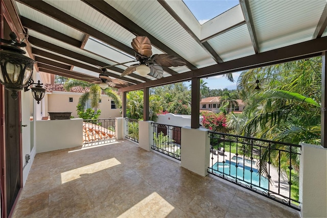 view of patio featuring a ceiling fan and a balcony