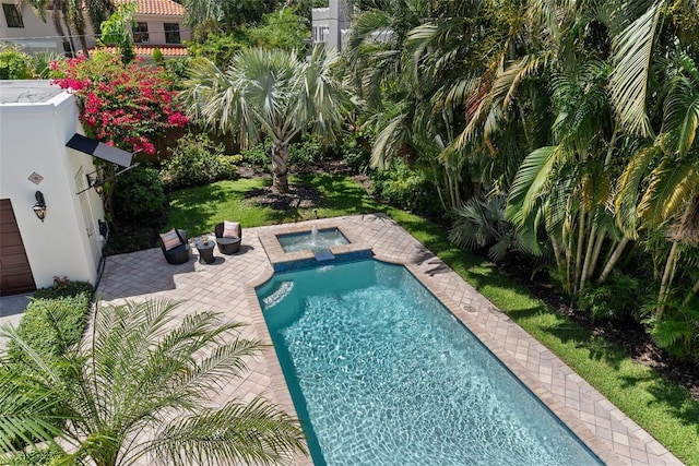 view of swimming pool with a pool with connected hot tub and a patio area