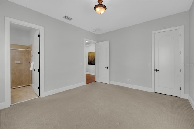 unfurnished bedroom featuring carpet, baseboards, and ensuite bathroom