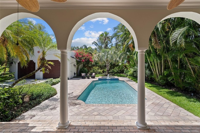 view of pool with a patio and a pool with connected hot tub
