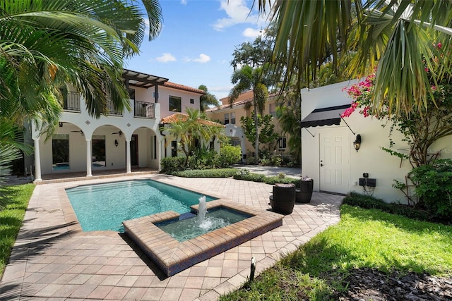 view of swimming pool with a patio and a pool with connected hot tub