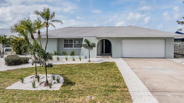 7092 S Shore Dr S, Saint Petersburg, FL 33707 - single story home featuring stucco siding, a garage, a front yard, and concrete driveway