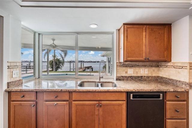 7092 S Shore Dr S, Saint Petersburg, FL 33707 - kitchen with dishwasher, a sink, brown cabinets, and light stone counters