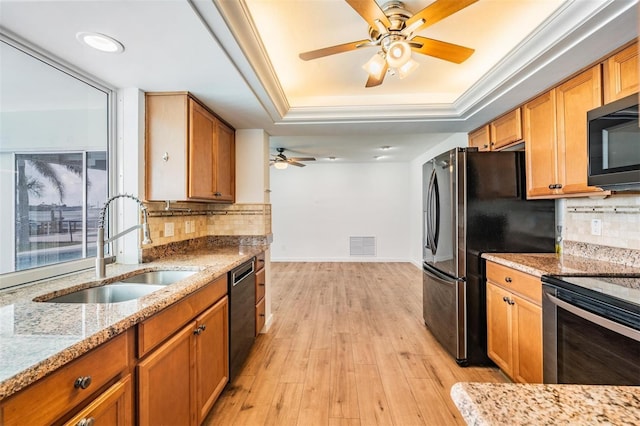 7092 S Shore Dr S, Saint Petersburg, FL 33707 - kitchen with a sink, stainless steel appliances, a tray ceiling, a ceiling fan, and tasteful backsplash
