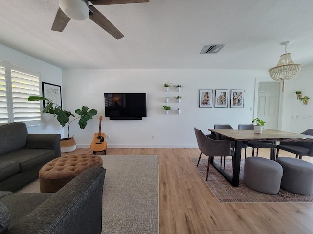 7092 S Shore Dr S, Saint Petersburg, FL 33707 - living area with ceiling fan, light wood-style floors, and baseboards