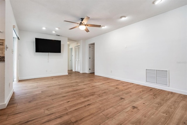7092 S Shore Dr S, Saint Petersburg, FL 33707 - unfurnished living room with a ceiling fan, light wood-style flooring, baseboards, and recessed lighting