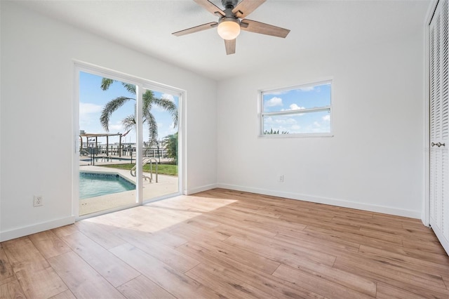 7092 S Shore Dr S, Saint Petersburg, FL 33707 - unfurnished room with light wood-style floors, ceiling fan, and baseboards