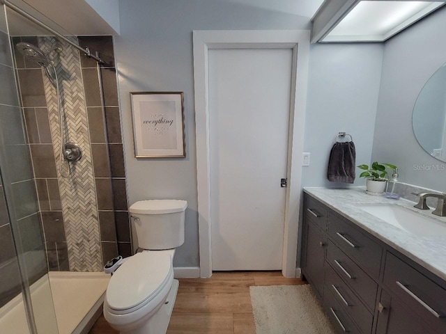 7092 S Shore Dr S, Saint Petersburg, FL 33707 - full bath with wood finished floors, a shower stall, vanity, and toilet
