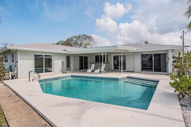7092 S Shore Dr S, Saint Petersburg, FL 33707 - rear view of property with a patio area, stucco siding, an outdoor pool, and roof with shingles