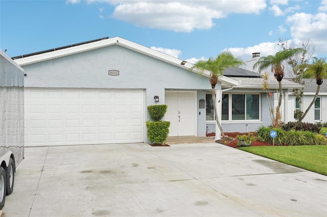 6010 Bayou Grande Blvd NE, Saint Petersburg, FL 33703 - ranch-style house featuring stucco siding, roof mounted solar panels, driveway, and a garage