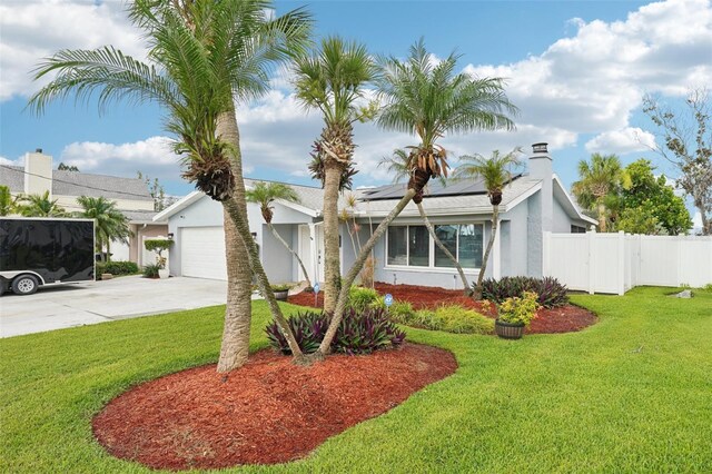6010 Bayou Grande Blvd NE, Saint Petersburg, FL 33703 - single story home with concrete driveway, solar panels, stucco siding, and a chimney