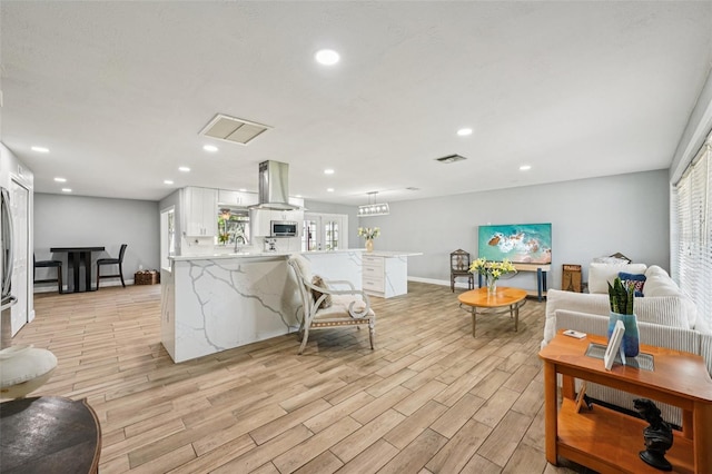 6010 Bayou Grande Blvd NE, Saint Petersburg, FL 33703 - living room featuring light wood-type flooring, plenty of natural light, and recessed lighting