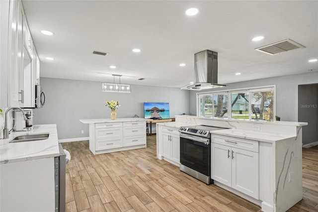 6010 Bayou Grande Blvd NE, Saint Petersburg, FL 33703 - kitchen with stainless steel appliances, island range hood, a spacious island, light wood finished floors, and recessed lighting