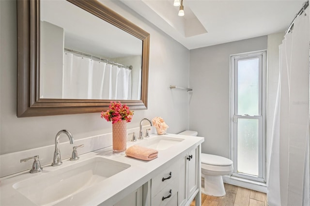 6010 Bayou Grande Blvd NE, Saint Petersburg, FL 33703 - full bath with double vanity, wood finished floors, and a shower with shower curtain