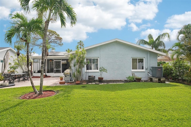 6010 Bayou Grande Blvd NE, Saint Petersburg, FL 33703 - back of house featuring a sunroom, a lawn, stucco siding, and a patio
