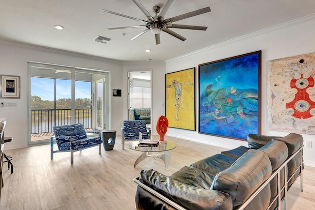 915 Tidewater Shores Loop, Bradenton, FL 34208 - living area featuring a ceiling fan, wood finished floors, healthy amount of natural light, ornamental molding, and baseboards