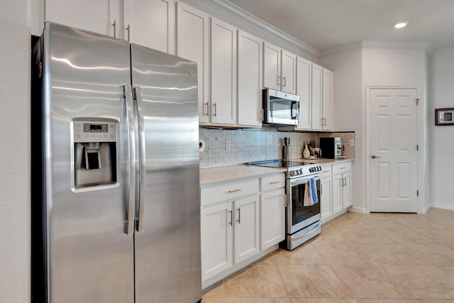 915 Tidewater Shores Loop, Bradenton, FL 34208 - kitchen with appliances with stainless steel finishes, light countertops, decorative backsplash, crown molding, and white cabinets