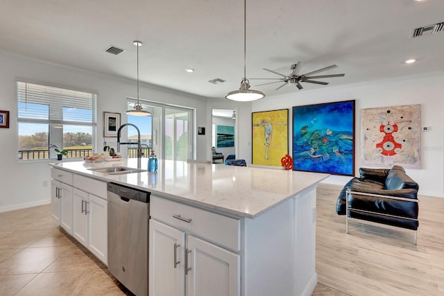 915 Tidewater Shores Loop, Bradenton, FL 34208 - kitchen featuring dishwasher, a sink, a ceiling fan, light stone counters, and white cabinets
