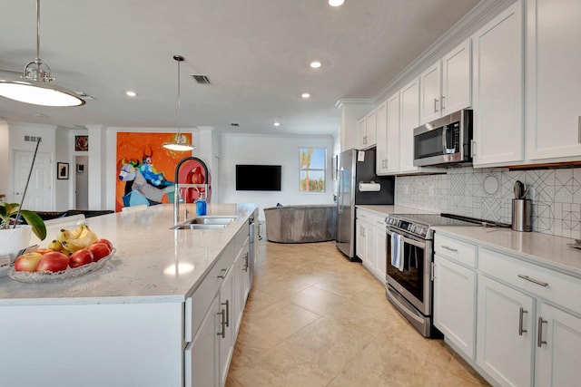 915 Tidewater Shores Loop, Bradenton, FL 34208 - kitchen featuring appliances with stainless steel finishes, a sink, open floor plan, backsplash, and recessed lighting