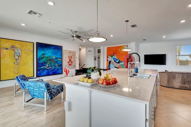 915 Tidewater Shores Loop, Bradenton, FL 34208 - kitchen with a sink, open floor plan, ornamental molding, recessed lighting, and a center island with sink
