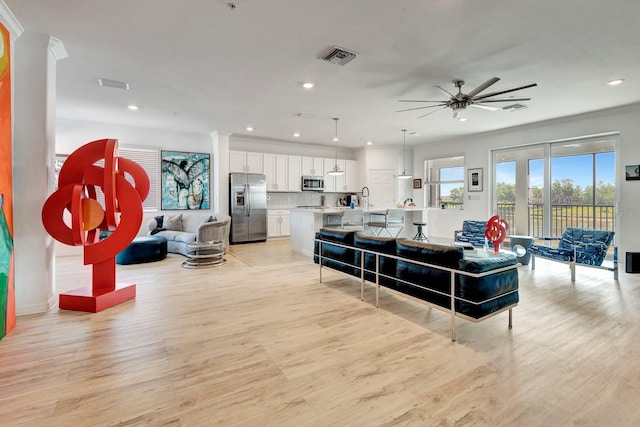 915 Tidewater Shores Loop, Bradenton, FL 34208 - living room with a ceiling fan, light wood-type flooring, recessed lighting, crown molding, and baseboards