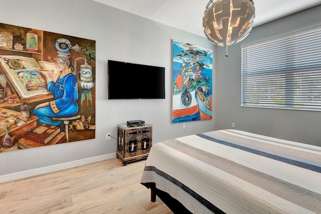 915 Tidewater Shores Loop, Bradenton, FL 34208 - bedroom with a chandelier, wood finished floors, and baseboards