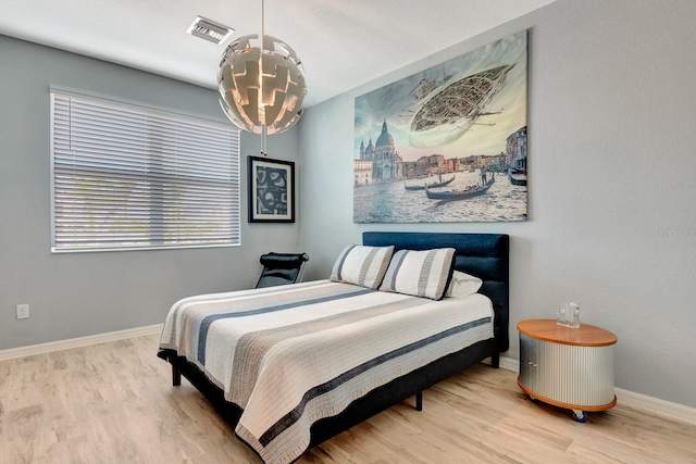 915 Tidewater Shores Loop, Bradenton, FL 34208 - bedroom with wood finished floors, a chandelier, and baseboards