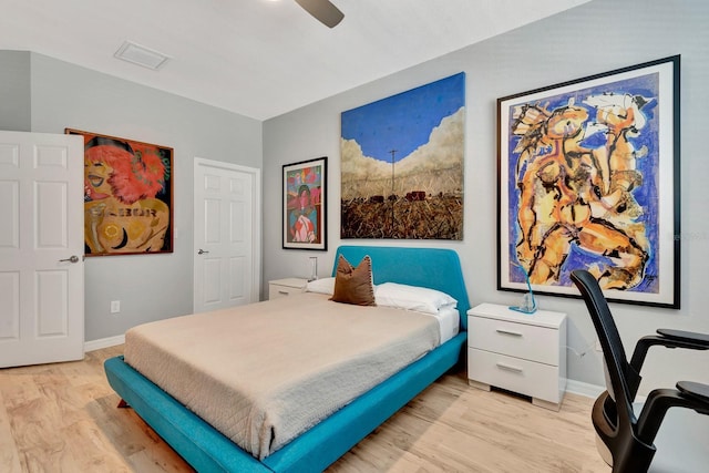 915 Tidewater Shores Loop, Bradenton, FL 34208 - bedroom with light wood-type flooring, baseboards, and a ceiling fan