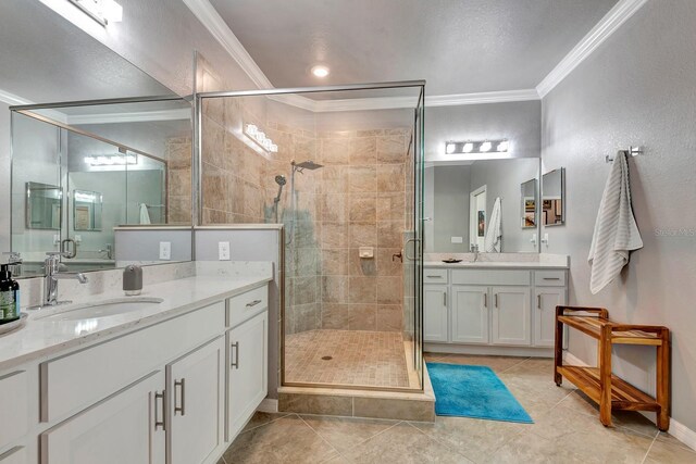 915 Tidewater Shores Loop, Bradenton, FL 34208 - bathroom featuring ornamental molding, a shower stall, tile patterned flooring, and two vanities