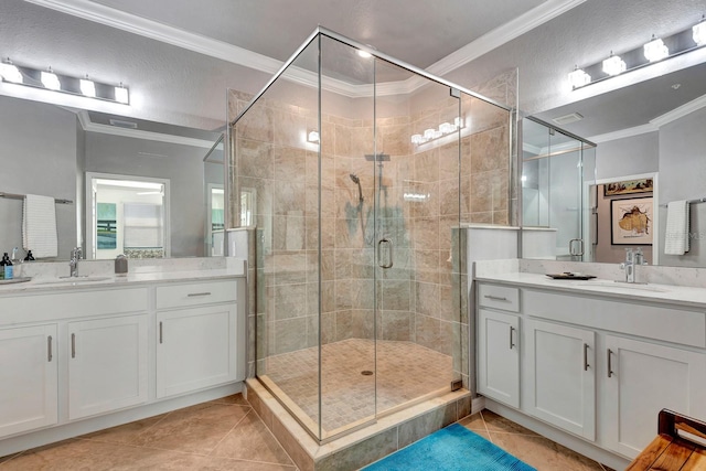 915 Tidewater Shores Loop, Bradenton, FL 34208 - full bath with crown molding, tile patterned floors, a stall shower, and two vanities