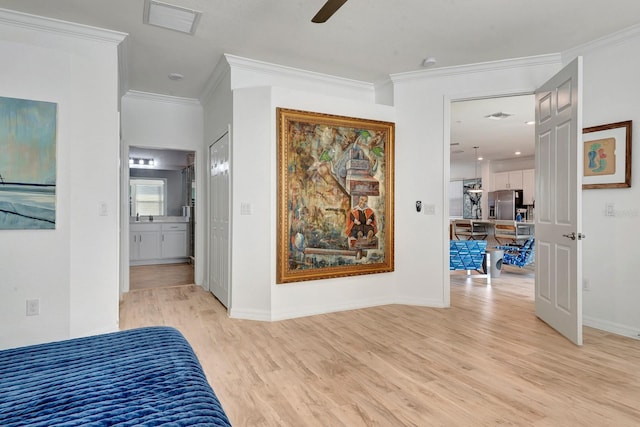 915 Tidewater Shores Loop, Bradenton, FL 34208 - bedroom with light wood-style floors, an office area, crown molding, stainless steel fridge, and baseboards