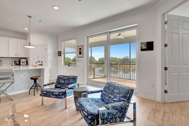 915 Tidewater Shores Loop, Bradenton, FL 34208 - sitting room featuring light wood-type flooring, ornamental molding, baseboards, a water view, and a ceiling fan