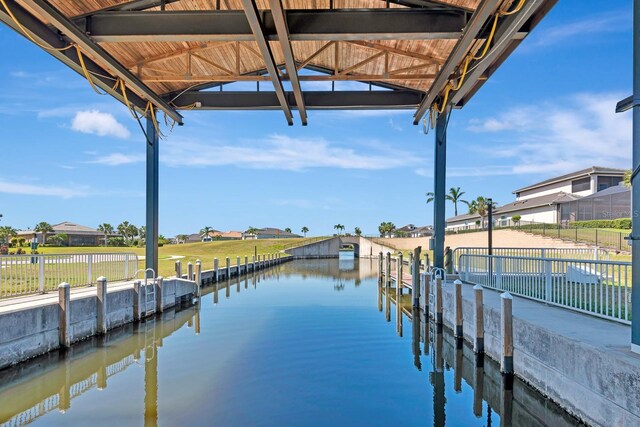 915 Tidewater Shores Loop, Bradenton, FL 34208 - dock featuring fence and a residential view