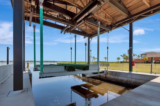915 Tidewater Shores Loop, Bradenton, FL 34208 - dock area featuring a water view, fence, and boat lift