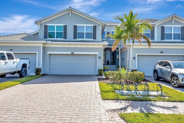 915 Tidewater Shores Loop, Bradenton, FL 34208 - view of front of property featuring a garage, decorative driveway, and stucco siding